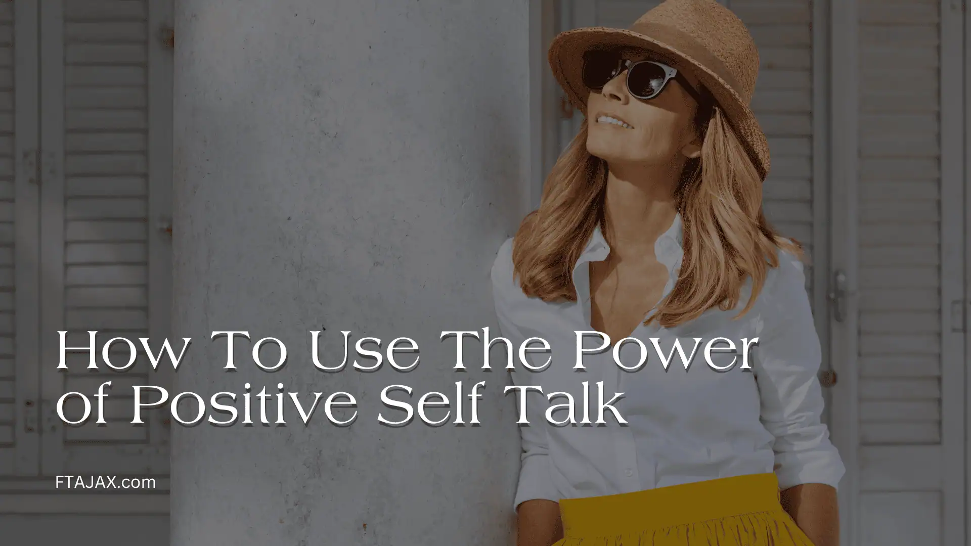 A woman in a white blouse and yellow skirt poses confidently against a textured wall, promoting positive self-talk